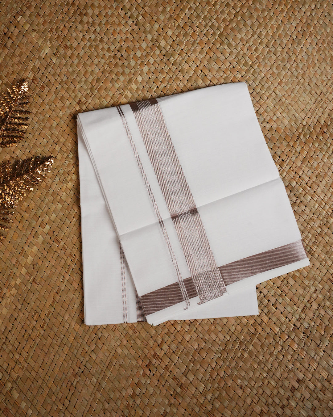 White colour cotton single dhoti featuring Rose Gold Kasav border.