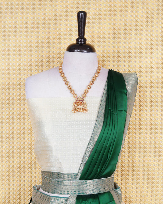 Cream colour  tissue Semi stitched dhavani set featuring Gold zari check pattern with motifs on body ,contrast Green colour with gold zari bordered skirt, paired with matching blouse piece & dupatta.