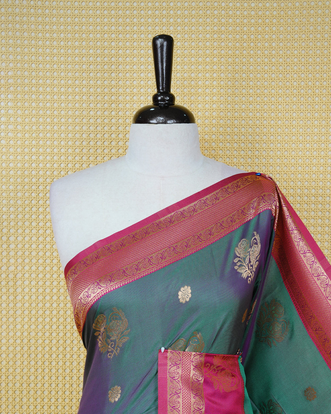 Green colour Mulberry silk saree featuring gold floral zari patterns on body, paired with contrast magenta colour with traditional border, comes with matching blouse piece.