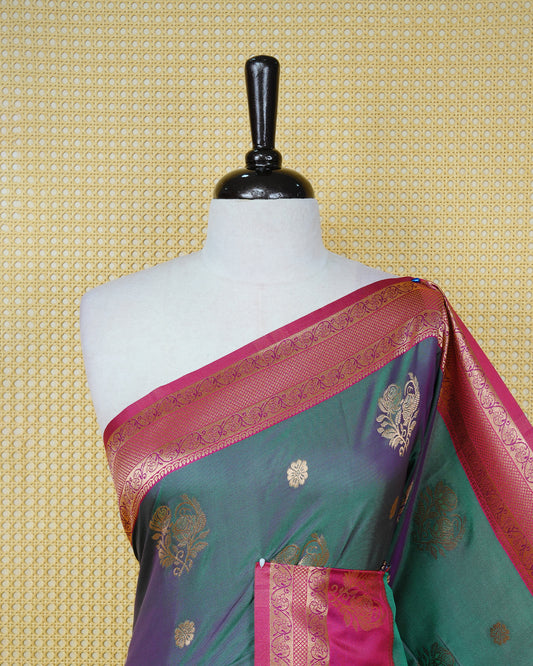 Green colour Mulberry silk saree featuring gold floral zari patterns on body, paired with contrast magenta colour with traditional border, comes with matching blouse piece.
