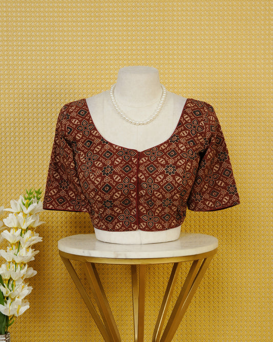 Maroon Colour Blouse Featuring A Classic U-Neck, Intricate Geometric Printed Design, And Comfortable Elbow Length Sleeves.