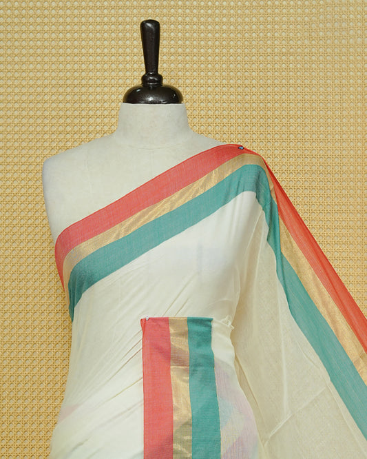 Cream colour Mul cotton saree featuring Elegant Plain body, complemented by contrast Red, Green & gold zari border & Tassels.