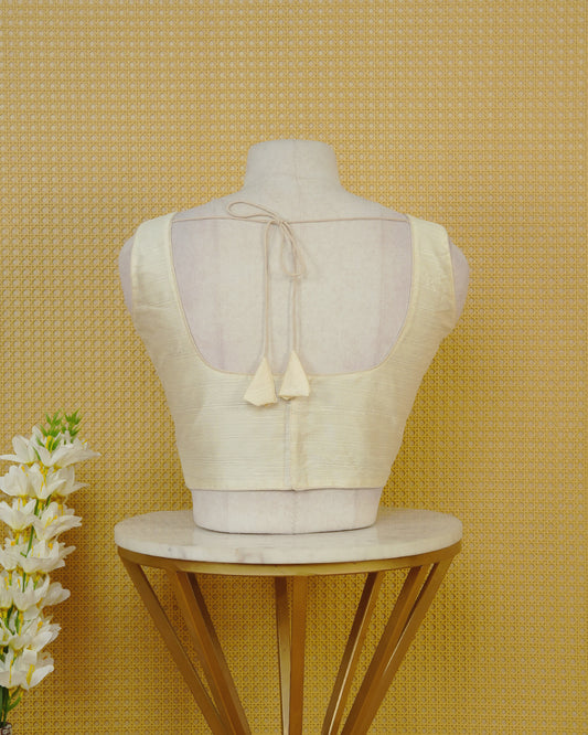 Cream Colour Plain Blouse Featuring A Classic U Neckline, Sleeveless Design, And A Simple, Clean Finish.