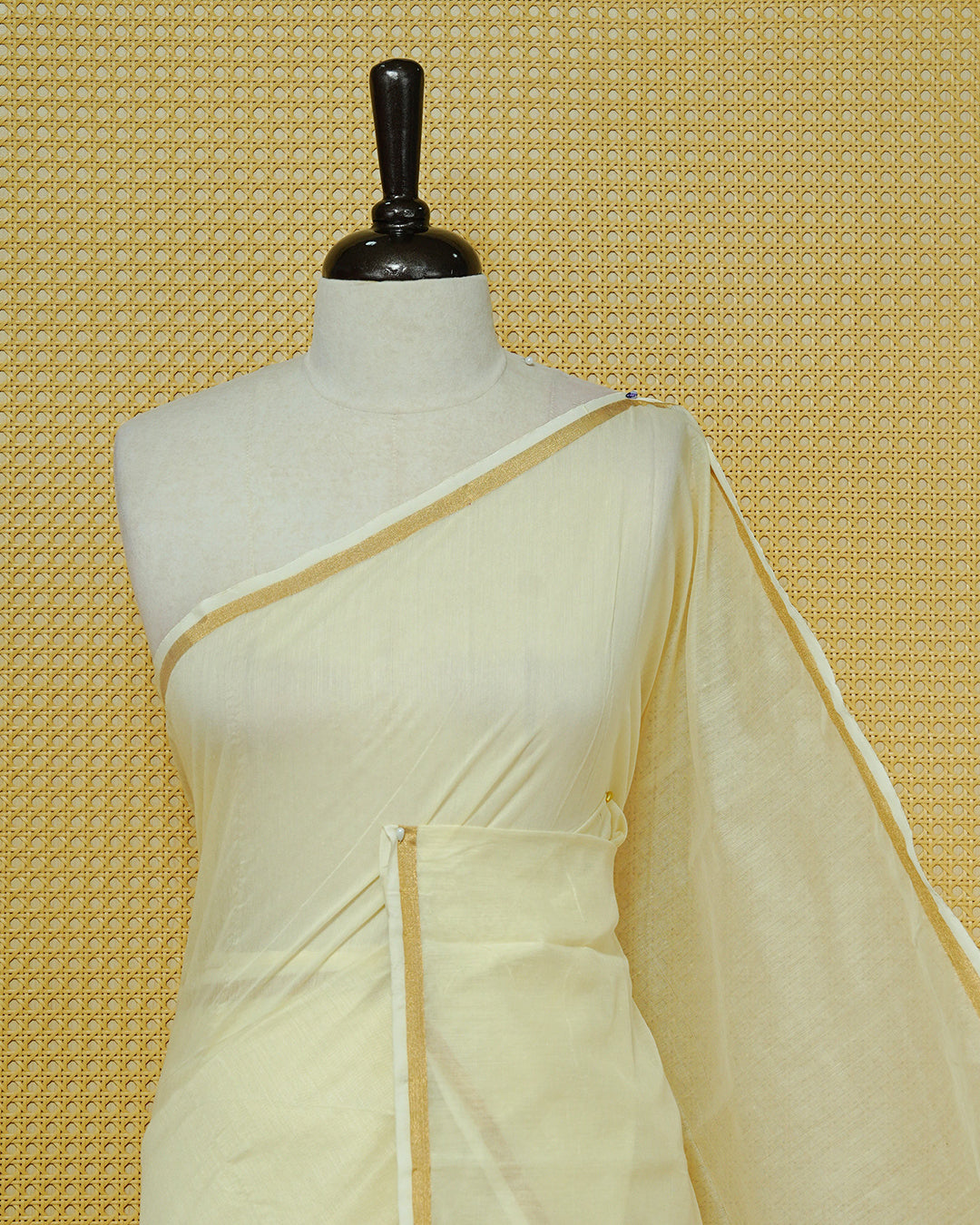Cream Mul Cotton Saree featuring a graceful plain body with a subtle gold zari border and a finely woven striped pallu. Finished with vibrant Yellow tassels
