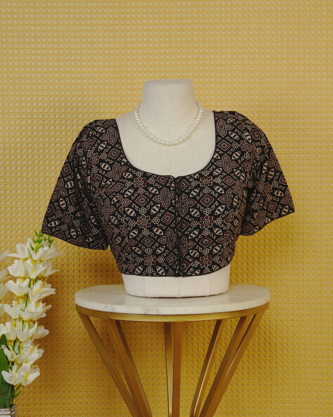 Black Colour Blouse Featuring A Classic U-Neck, Intricate Geometric Printed Design, And Comfortable Elbow Length Sleeves.