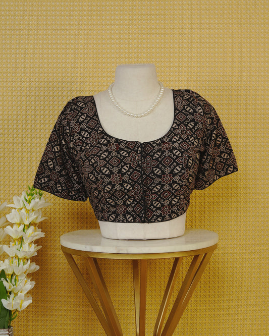 Black Colour Blouse Featuring A Classic U-Neck, Intricate Geometric Printed Design, And Comfortable Elbow Length Sleeves.