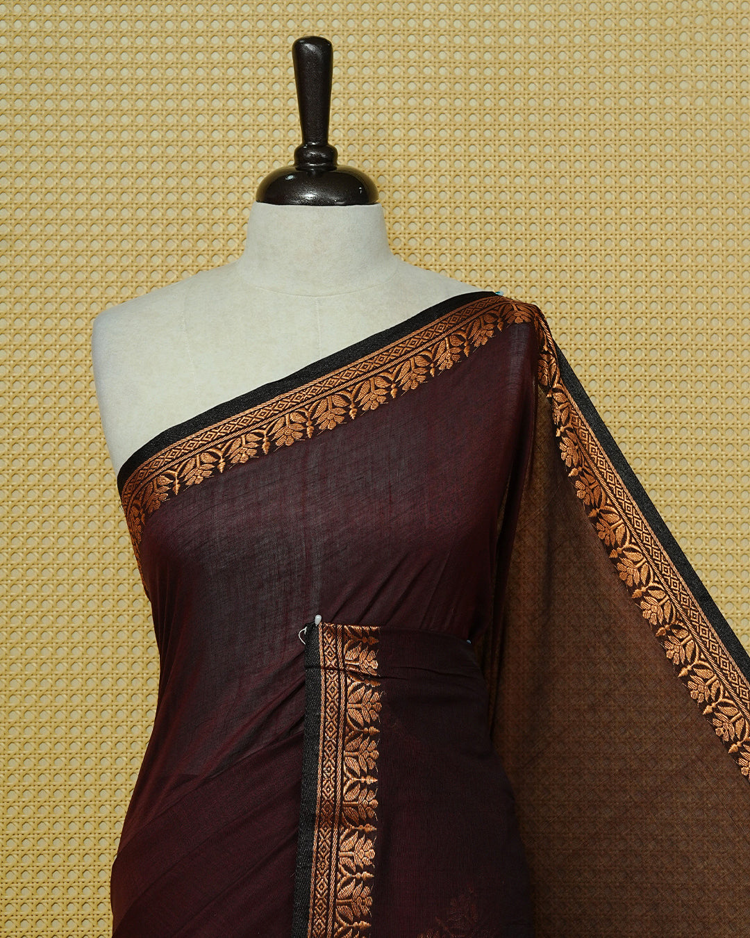 Chocolate brown colour Mul cotton saree featuring an elegant plain body, complemented by self colour with Gold zari border & tassels.
