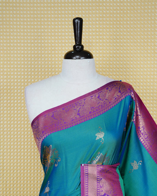 Peacock green Mulberry silk saree featuring gold floral zari patterns on body, paired with contrast wine colour with traditional border, comes with matching blouse piece.