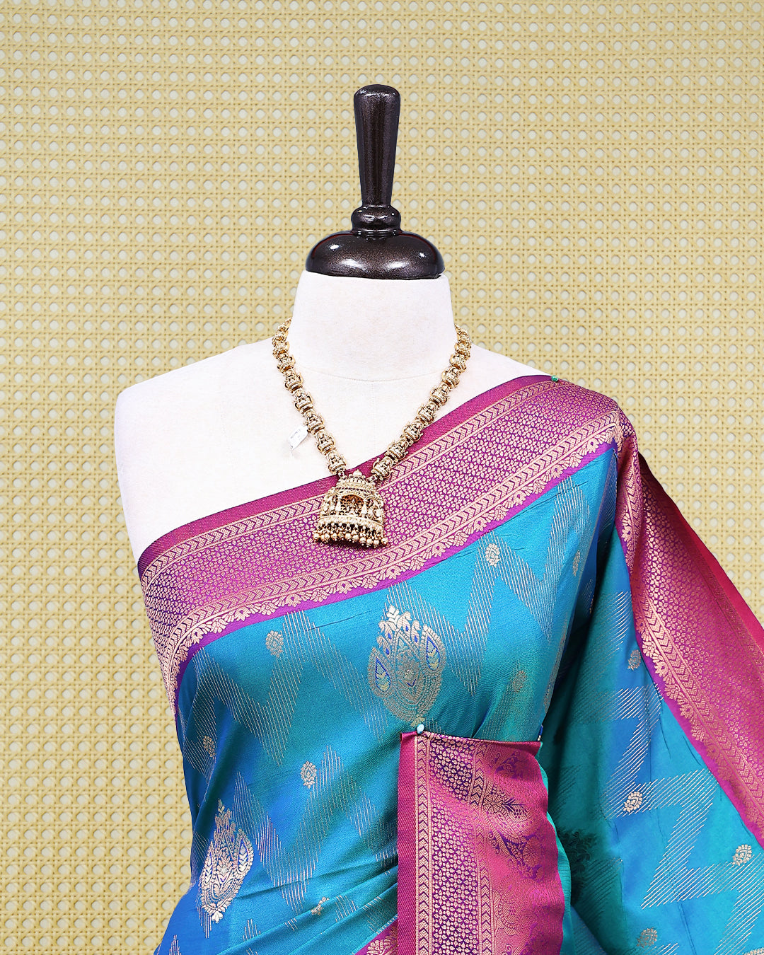 Teal colour Mulberry silk saree featuring floral gold zari patterns on body, paired with contrast Purple colour with traditional border, comes with matching blouse piece.
