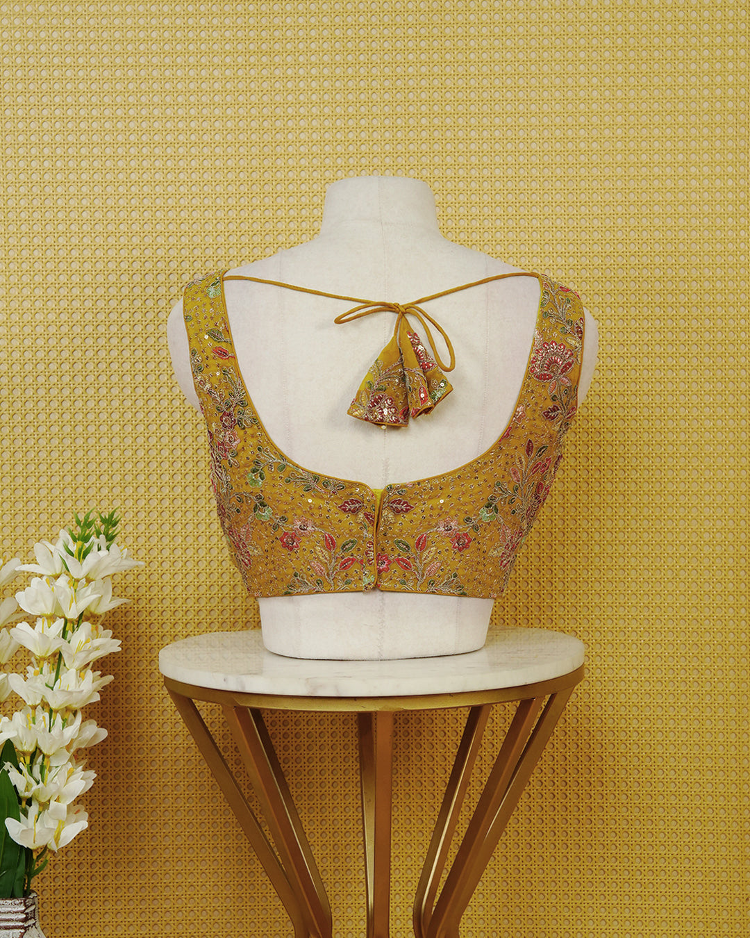 Mustard Yellow colour Sleeveless Blouse Featuring A Stylish V-Neck, Intricate Floral Embroidery With Sequin Detailing, And A Comfortable Tailored Fit.