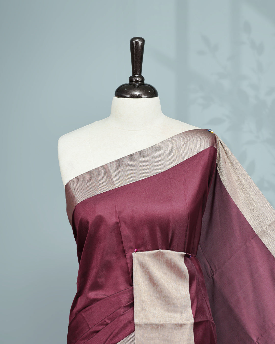 Wine colour saree featuring a plain body, complemented by a Bavanchi border and contrast pallu, paired with a matching blouse piece..