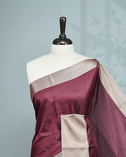 Wine colour saree featuring a plain body, complemented by a Bavanchi border and contrast pallu, paired with a matching blouse piece..
