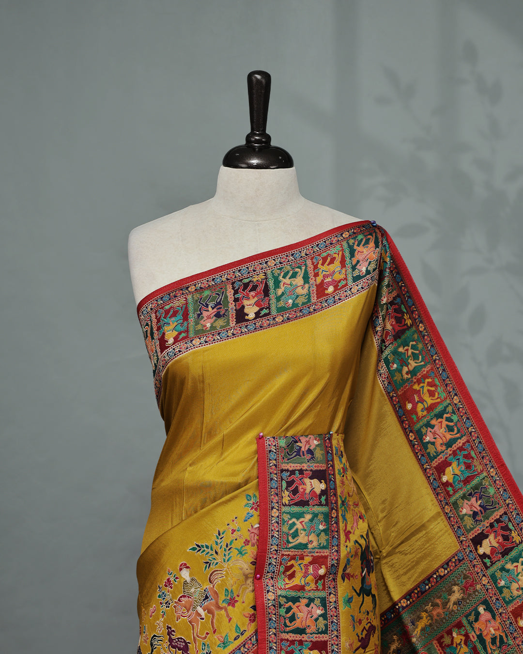 Mustard Colour Pashmina Saree featuring Plain body, complemented by Contrast Red colour with Man With Horse pattern & gold zari on border and Pallu, comes with matching blouse piece.