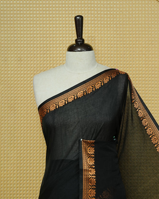 Black Colour Mul Cotton Saree featuring a plain body, complemented by a copper zari border and black tassels.