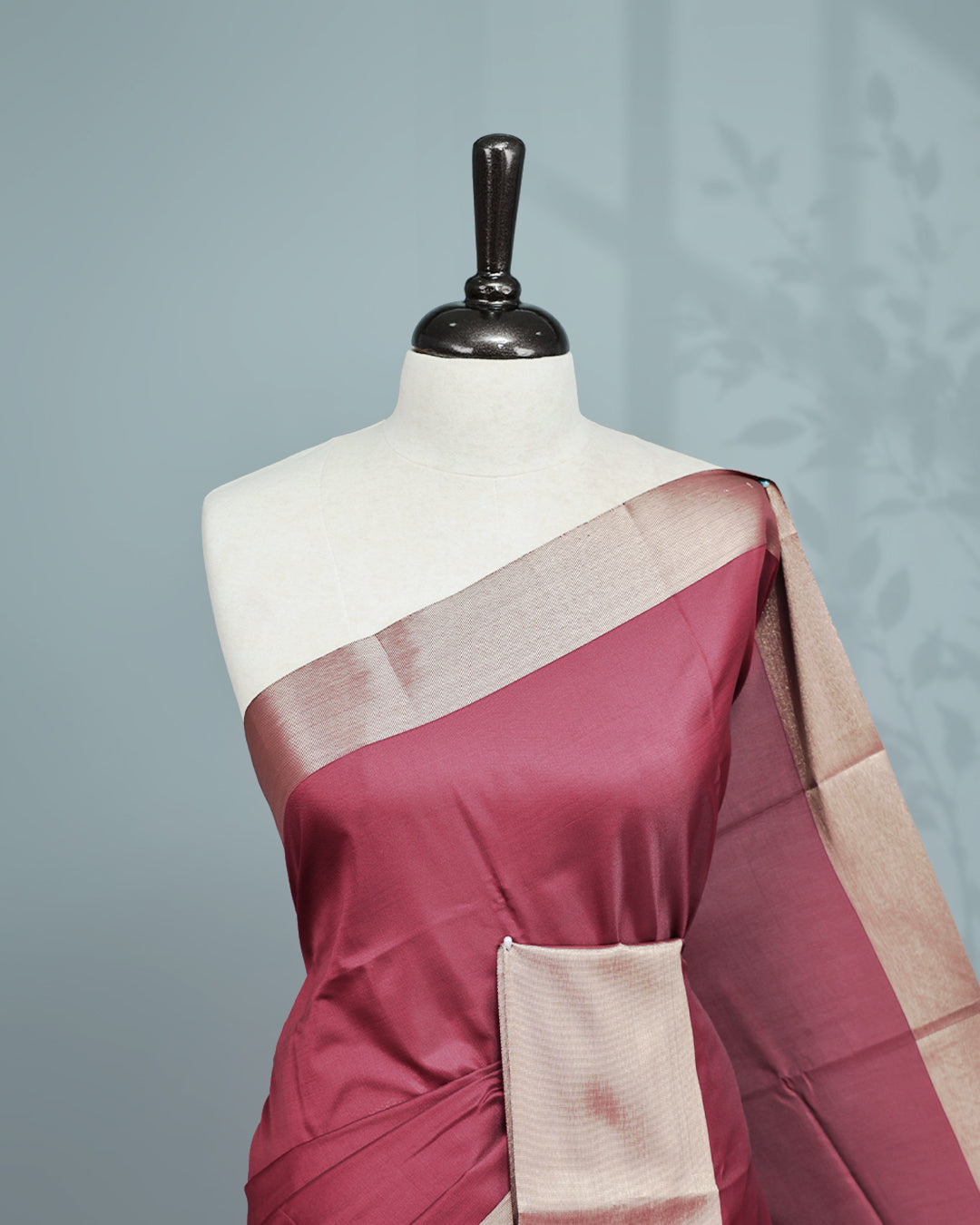 Maroon colour saree featuring a plain body, complemented by a Bavanchi border and contrast pallu, paired with a matching blouse piece.