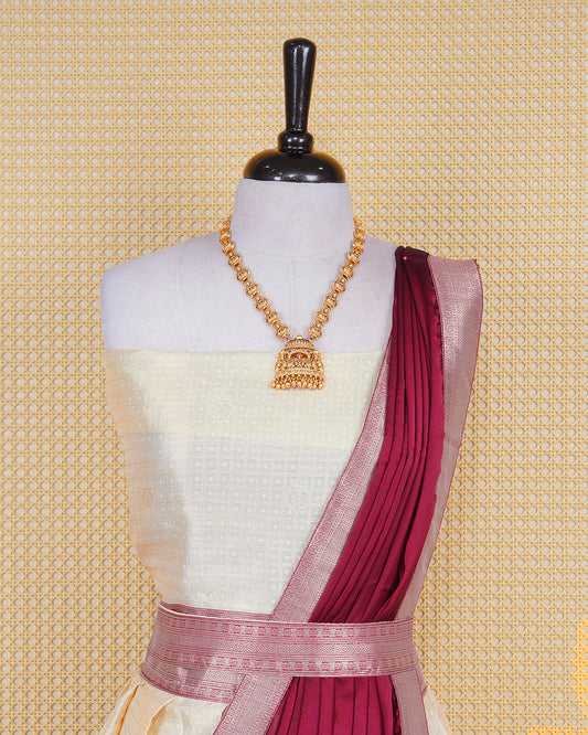 Cream colour  tissue  Semi stitched dhavani set featuring Gold zari check pattern with motifs on body ,contrast Brick Red colour with gold zari bordered skirt, paired with matching blouse piece & dupatta.