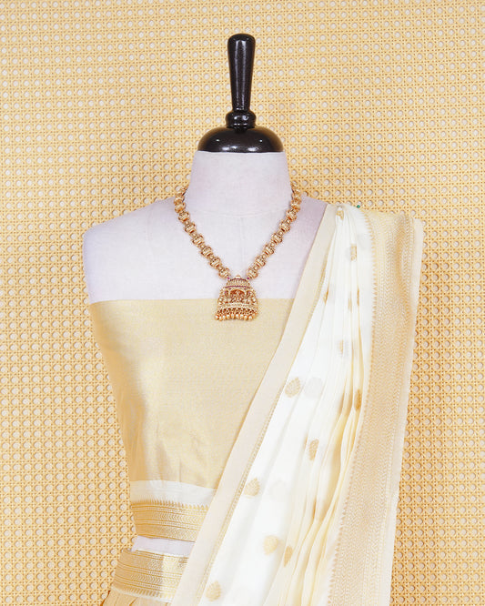 Cream coloured tissue semi stitched dhavani set featuring gold zari Motifs on the body with a matching gold zari bordered skirt & blouse piece and dupatta.