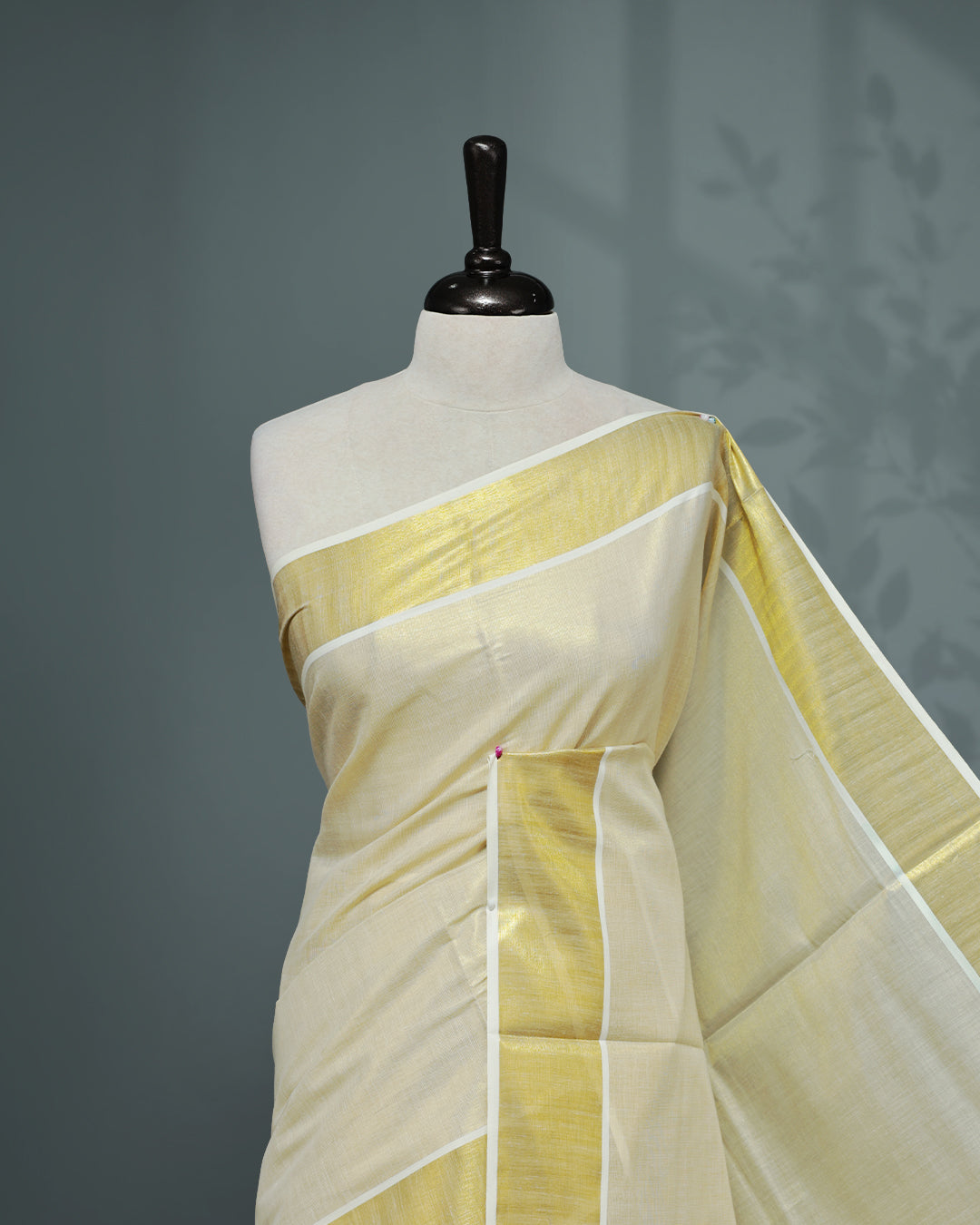 Cream colour Tissue Kerala saree Featuring An Elegant plain body, complemented by a classic gold zari border, matching blouse piece.