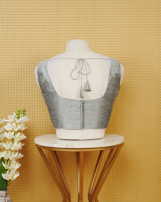 Silver colour Sleeveless Blouse Featuring A Classic Scoop Neck, Smooth Finish, And A Comfortable Tailored Fit.