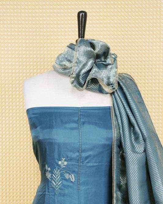 Steel Blue Silk Salwar Material Features an Elegent Floral Embroidary Pattern Aborned With Shimmering Metallic Gold Thread and Lace Border Work, paired with matching bottom & elegant Duptta