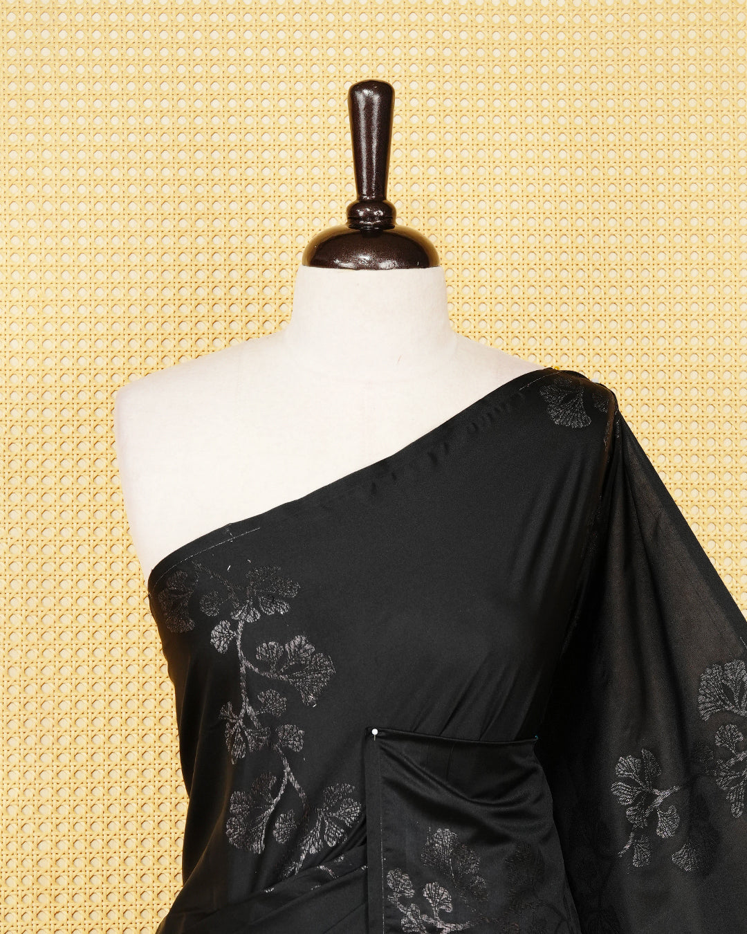 Black colour soft silk saree featuring antique zari motifs on body with contrast dusty rose colour pallu & paired with matching blouse piece.