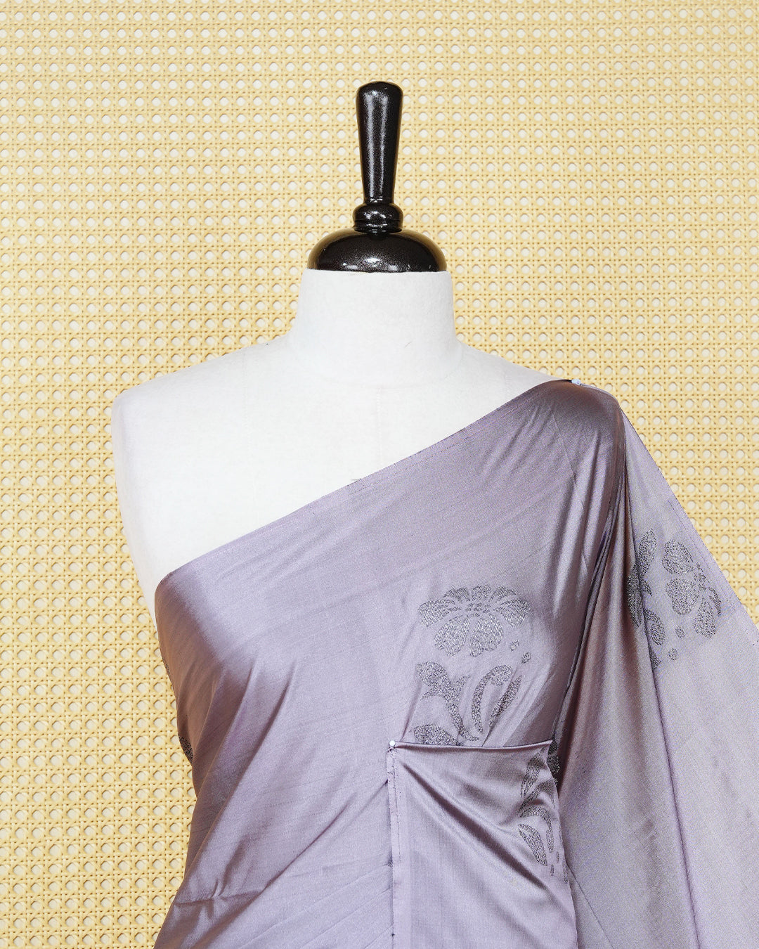 Greyish lavender colour soft silk saree featuring antique zari motifs on body with contrast dark maroon colour pallu & paired with matching blouse piece.