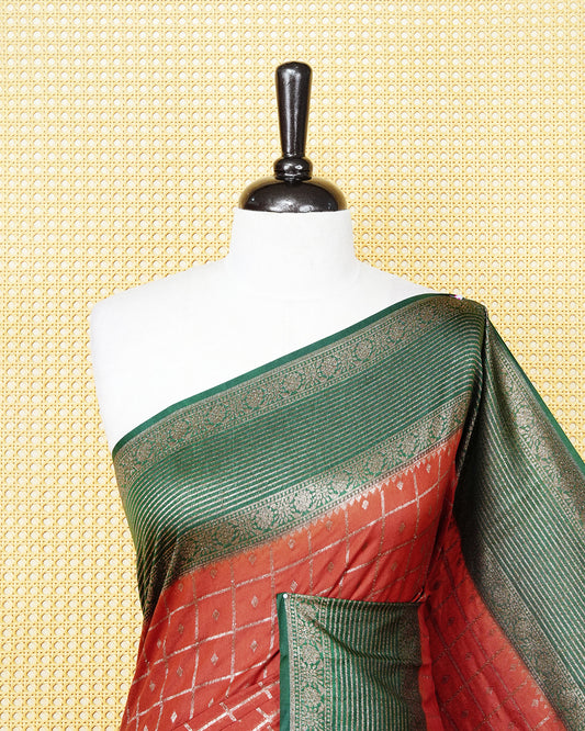 Burnt orange Colour Semi georgette Saree having zari check with buttas pattern on body, contrast dark green colour floral designed border, Rich Pallu comes with Matching Blouse piece.