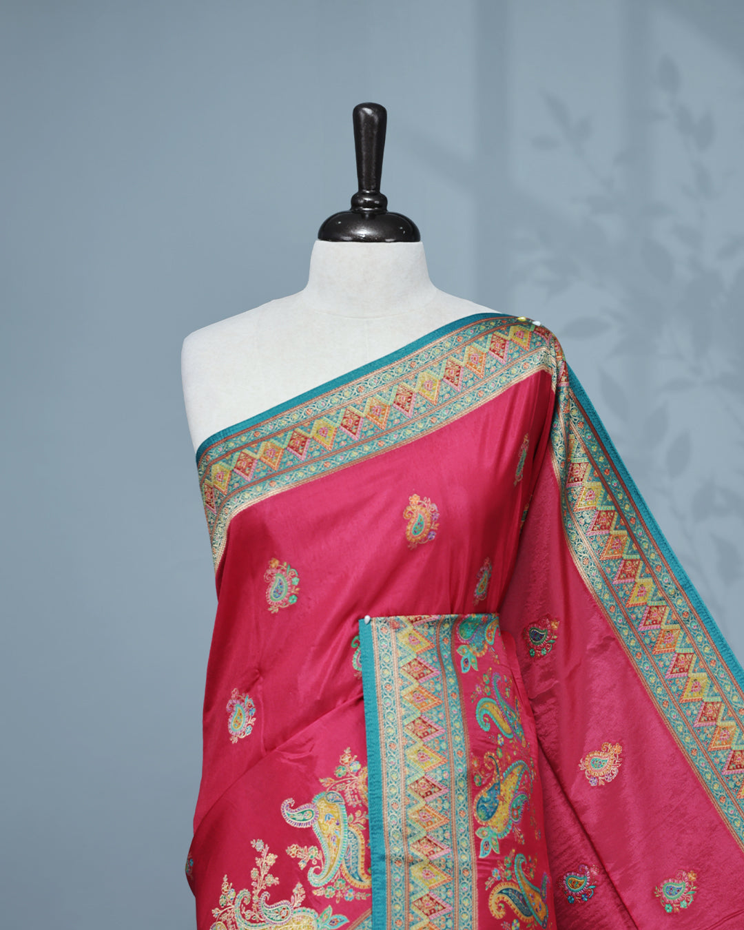Rani Pink Colour Pashmina Saree featuring Mango motifs on body, complemented by Contrast Teal colour with Floral pattern & gold zari on border and Pallu, comes with matching blouse piece.