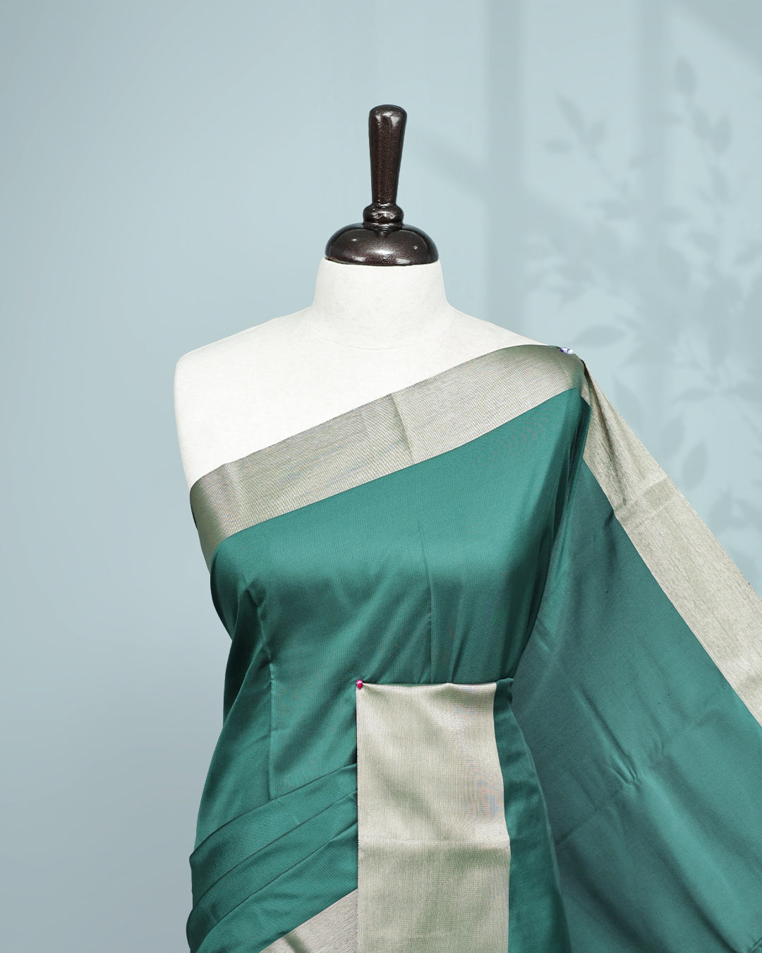Green colour saree featuring a plain body, complemented by a Bavanchi border and contrast pallu, paired with a matching blouse piece.