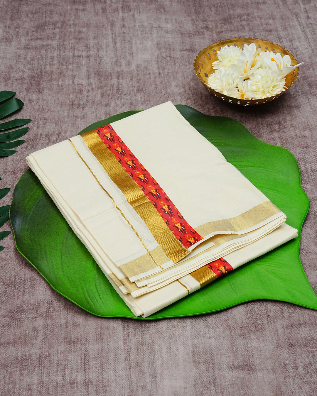 Cream Coloured Cotton Double Dhoti Finished with Elephant & Nettipattam Prints & Gold Kara