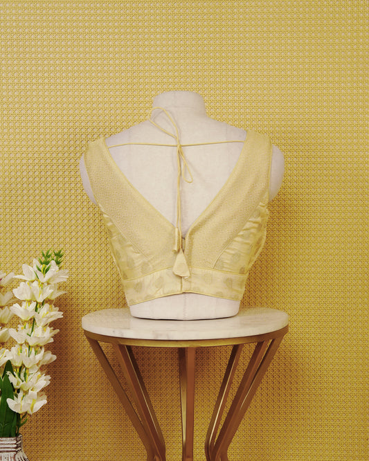 Gold colour Sleeveless Blouse Featuring A Stylish V-Neck, Elegant Woven Pattern With Gold Butta Motifs, And A Comfortable Tailored Fit.