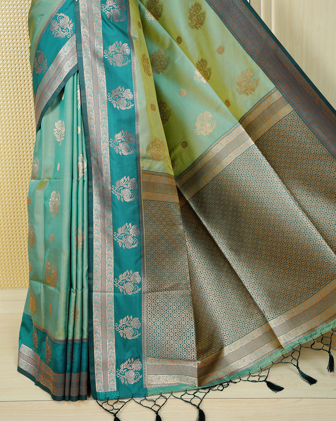 Olive green & gold double shade Mulberry silk saree featuring floral gold zari patterns on body, paired with contrast teal colour with traditional border, comes with matching blouse piece.
