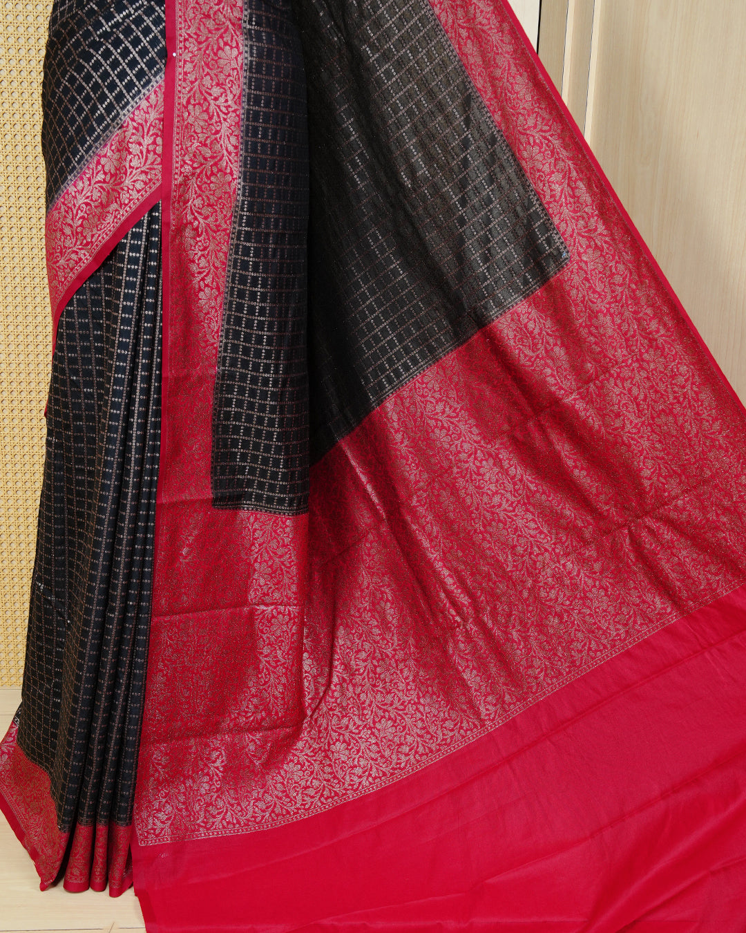 Black Colour Semi georgette Saree having zari dotted check pattern on body, contrast Red colour floral kodi designed Border, Rich Pallu comes with Matching Blouse piece.