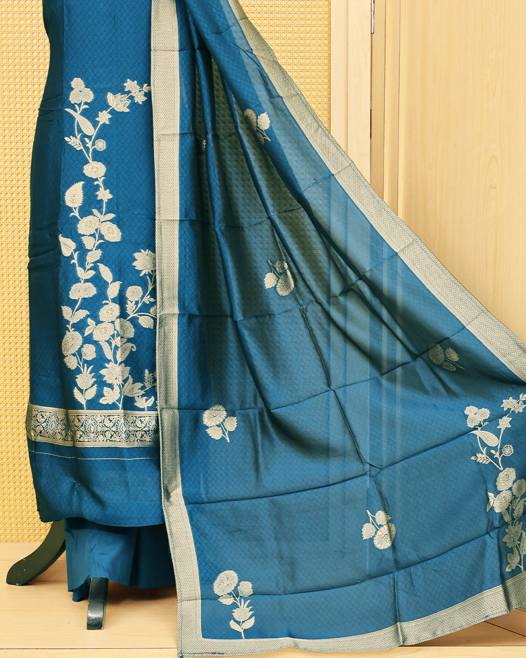 Blue colour Banaras salwar material featuring Zari floral work on body, paired with Matching bottom & dupatta.