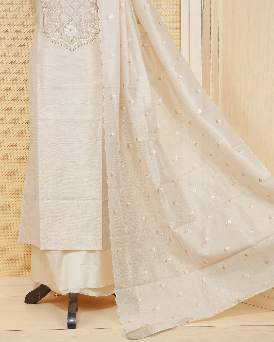 Cream colour tissue salwar material featuring elegant floral embroidery pattern adorned with Mirror and beadswork on Top, paired with matching bottom and elegant dupatta.