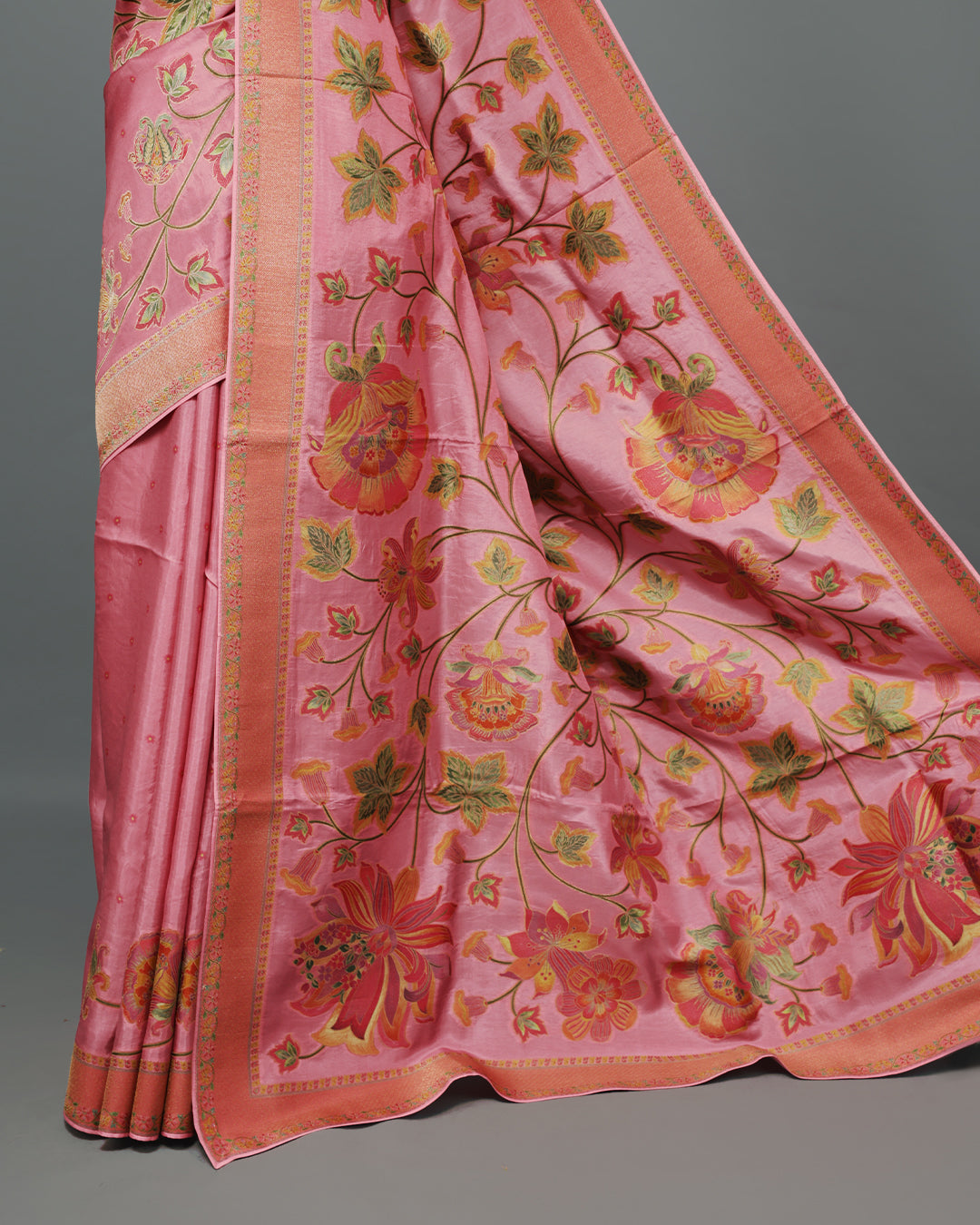 Pink Colour Pashmina Saree featuring Plain body, complemented by Contrast Peach colour with Floral pattern & gold zari on border and Pallu, comes with matching blouse piece.