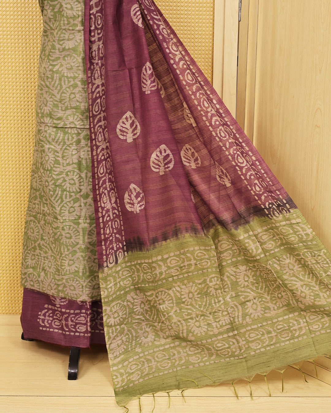 Green colour with Batik Printed  chanderi Salwar Material paired with a rich Plum Purple printed bottom and a matching contrast dupatta featuring traditional leaf motifs and artistic borders