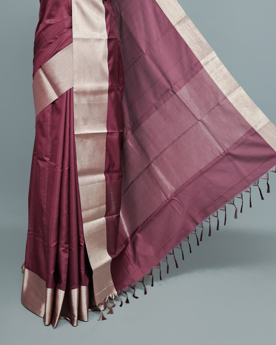 Wine colour saree featuring a plain body, complemented by a Bavanchi border and contrast pallu, paired with a matching blouse piece..