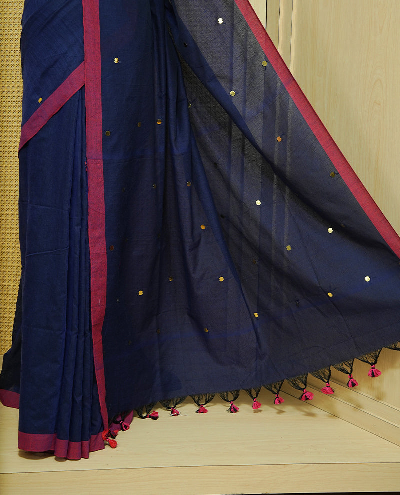 Navy Blue colour Mul cotton saree featuring Gold Sequins, complemented by Contrast Magenta simple Border & tassels.
