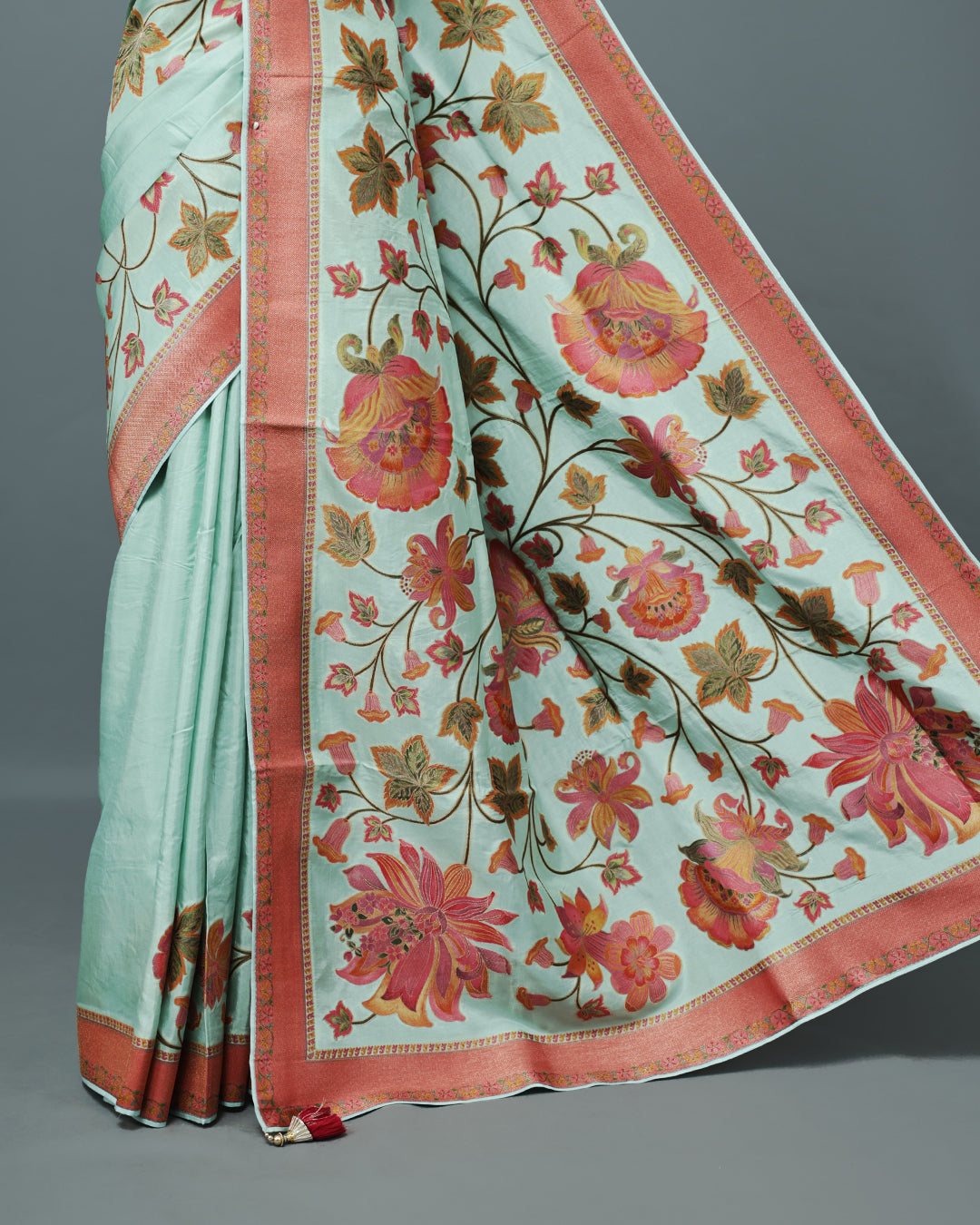 Ice Blue Colour Pashmina Saree featuring Plain body, complemented by Contrast Brick red colour with Floral pattern & gold zari on border and Pallu, comes with matching blouse piece.