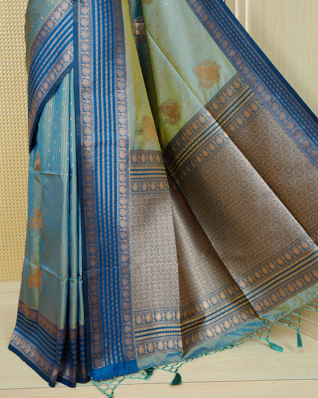 Green & gold double shade Mulberry silk saree featuring floral gold zari patterns on body , paired with contrast teal colour with traditional border, comes with matching blouse piece.