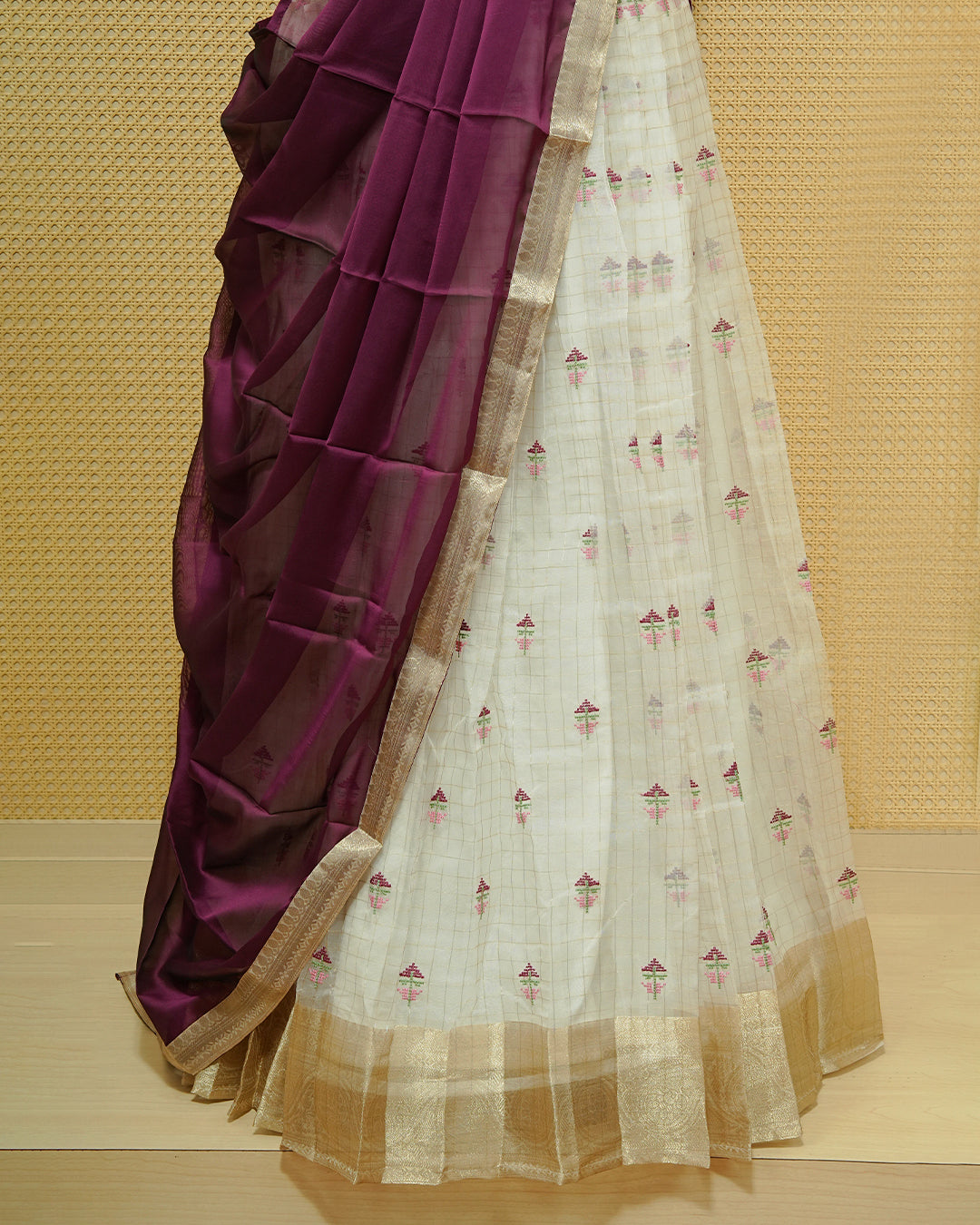 Cream colour Semi stitched Dhavani set featuring Gold zari checked pattern with floral motifs on skirt with traditional border, comes with contrast Colour Dupatta & matching blouse piece.