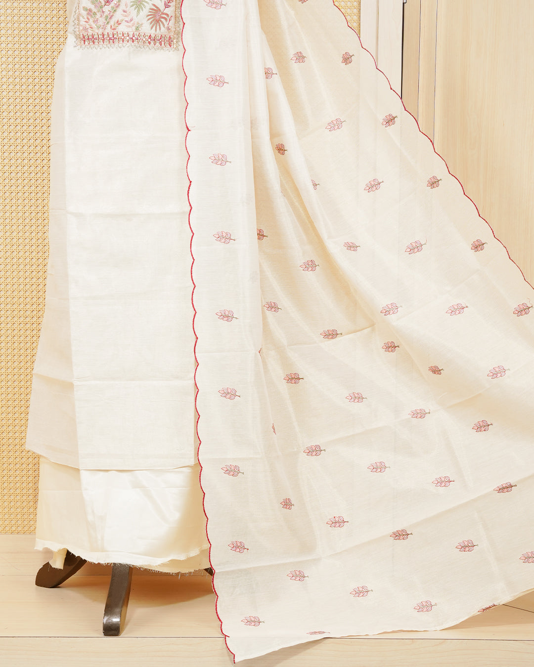 Cream tissue salwar material featuring elegant floral embroidery pattern adorned with beadwork, paired with matching bottom and elegant dupatta.