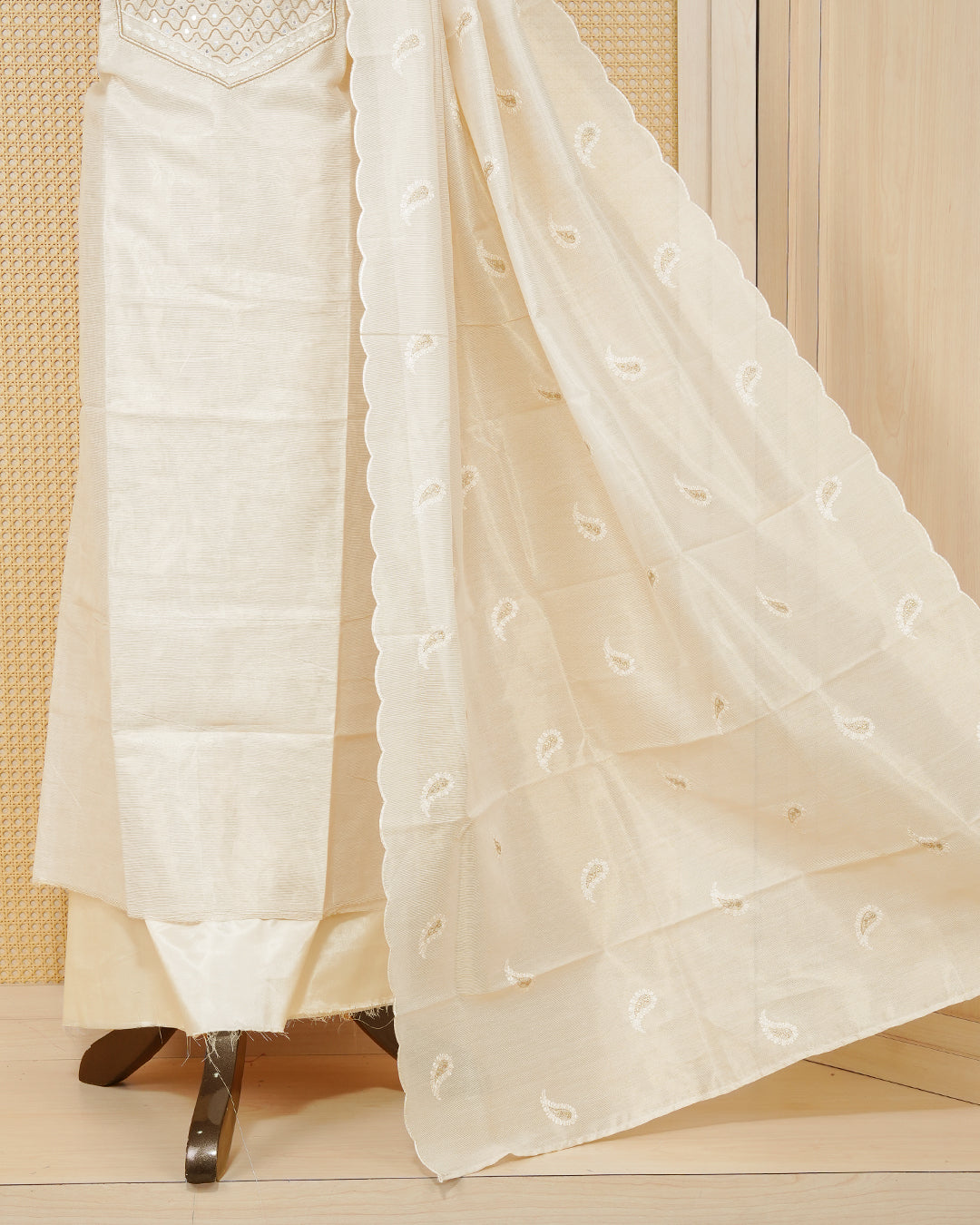 Cream colour tissue salwar material featuring elegant floral embroidery pattern adorned with Mirror and beadswork on Top, paired with matching bottom and elegant dupatta.