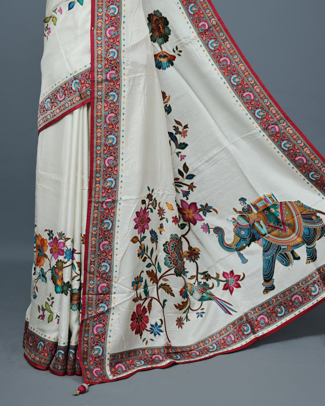 Cream Colour Pashmina Saree featuring a Patterned body, complemented by Contrast Magenta colour with Floral pattern & gold zari on border and Pallu, comes with matching blouse piece.