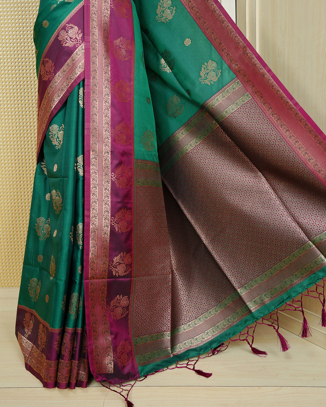 Green colour Mulberry silk saree featuring gold floral zari patterns on body, paired with contrast maroon colour with traditional border, comes with matching blouse piece.