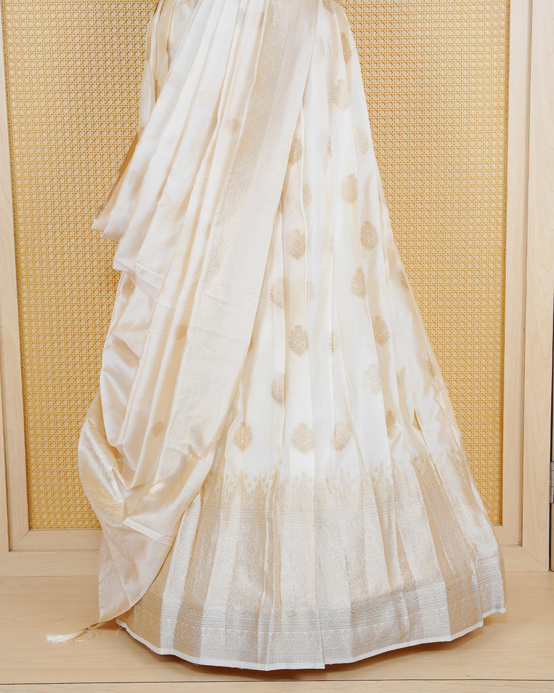 Cream coloured semi silk semi stitched dhavani set featuring gold zari Motifs on the body with a matching gold zari bordered skirt & blouse piece and dupatta.