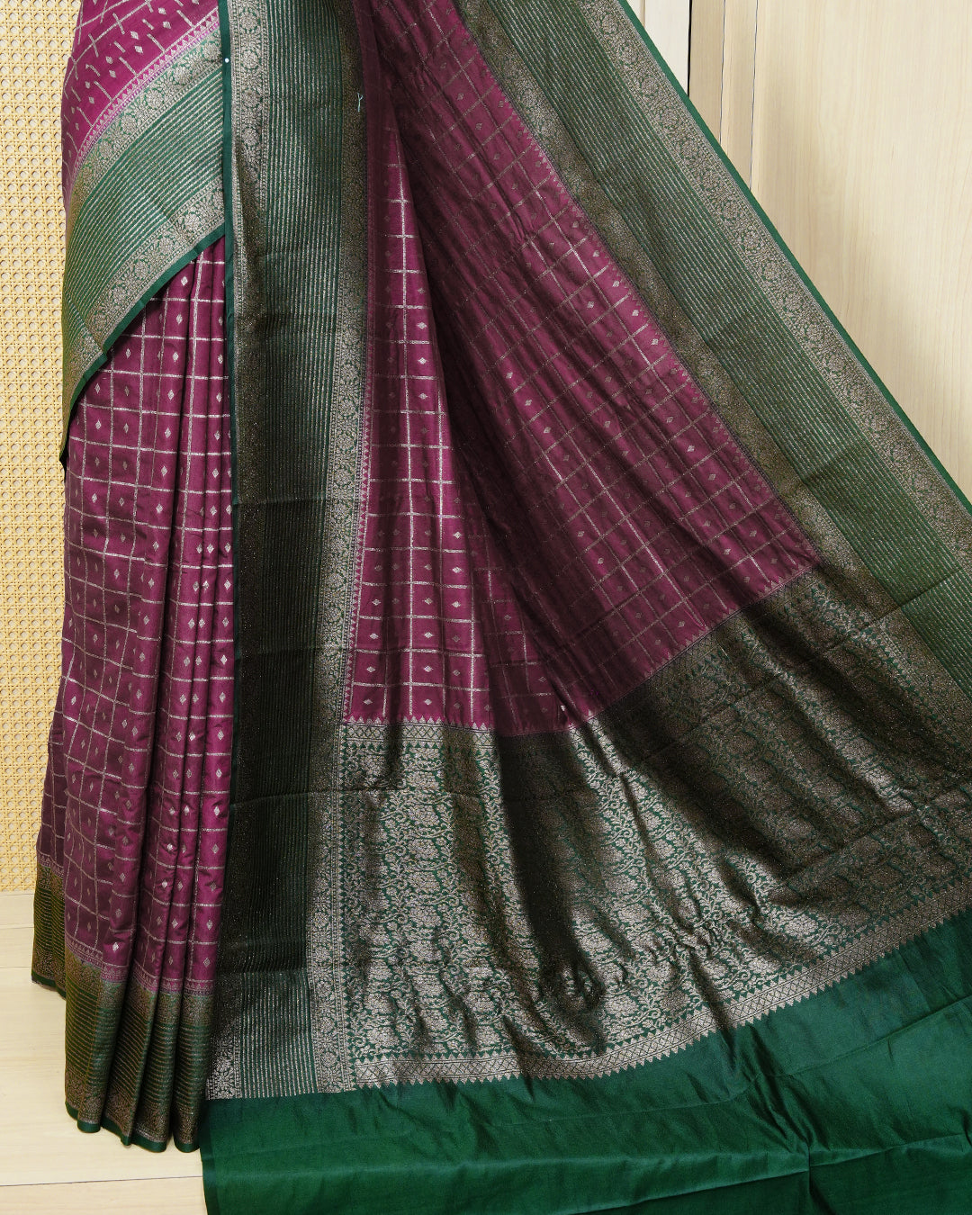 Grape Colour Semi georgette Saree having zari check with buttas pattern on body, contrast dark green colour floral designed border, Rich Pallu comes with Matching Blouse piece.