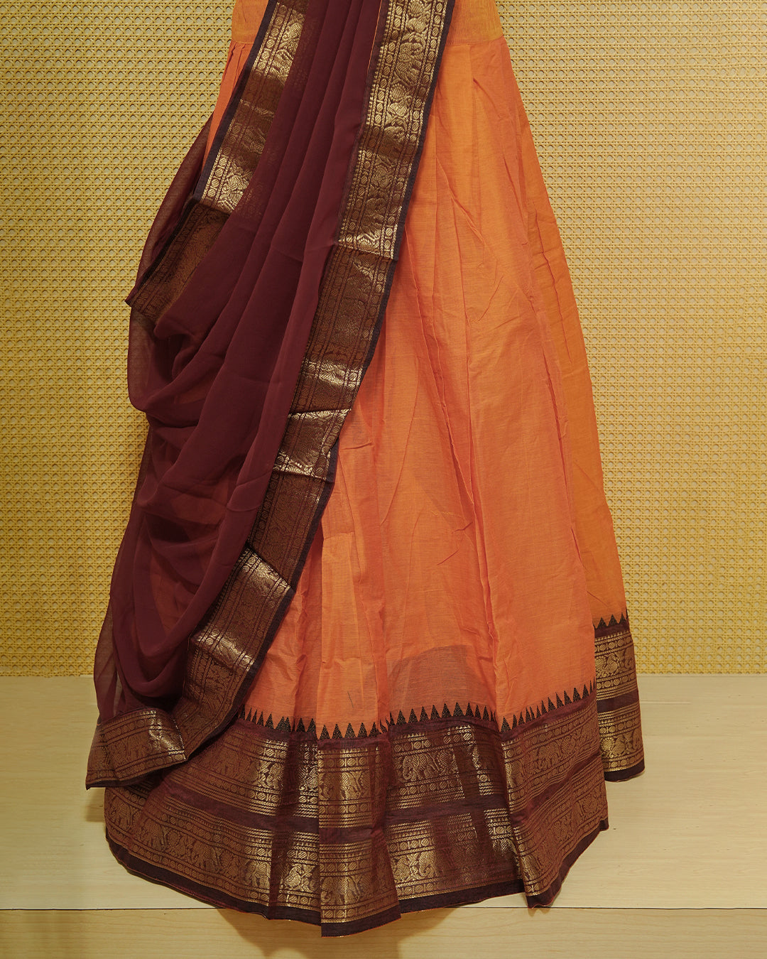 Orange colour Chettinad Semi Stitched dhavani set Featuring contrast Maroon with Gold zari border on skirt, Contrast Blouse & matching dupatta.