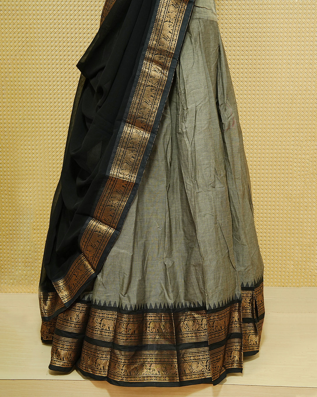 Grey colour Chettinad Semi Stitched dhavani set Featuring contrast Black with Gold zari border on skirt, Contrast Blouse & matching dupatta.